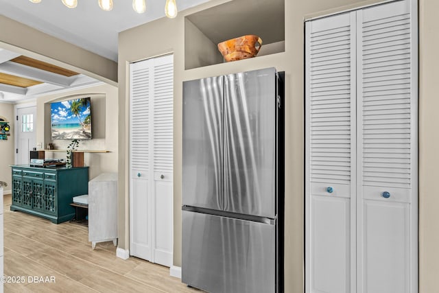 kitchen with beam ceiling and stainless steel fridge