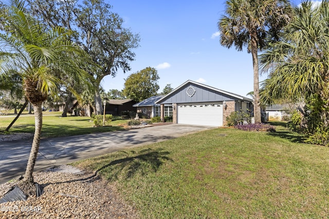 ranch-style home featuring a garage and a front lawn