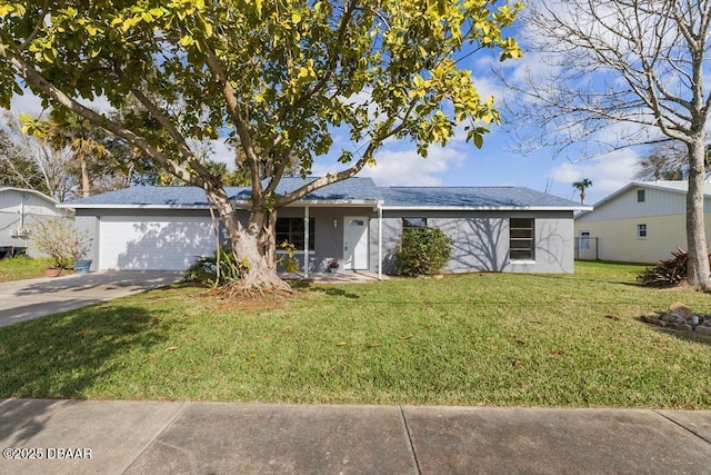 ranch-style house featuring a garage, concrete driveway, and a front yard