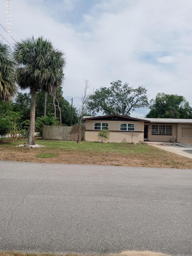 exterior space with driveway, fence, and a garage