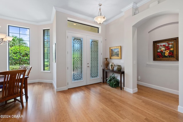 entrance foyer featuring ornamental molding, french doors, and a healthy amount of sunlight