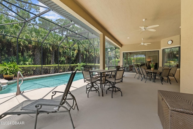 view of pool featuring ceiling fan, a lanai, and a patio area