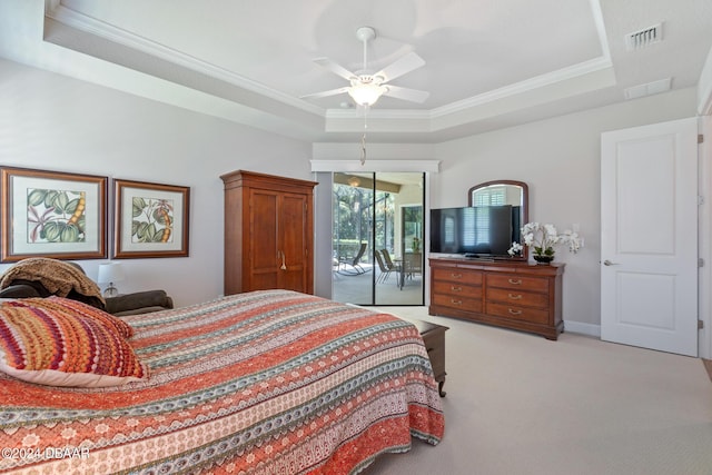 bedroom with light carpet, ceiling fan, a tray ceiling, ornamental molding, and access to exterior