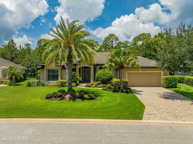 view of front facade with a front yard and a garage