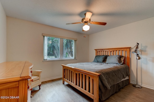 bedroom featuring hardwood / wood-style floors and ceiling fan