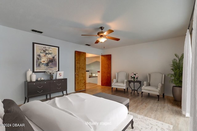 bedroom with ceiling fan and light hardwood / wood-style floors