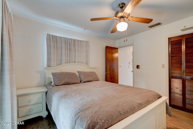 bedroom with wood-type flooring, a closet, and ceiling fan