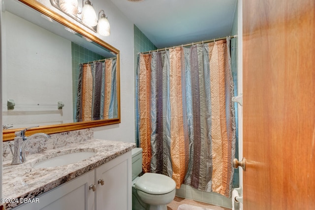 bathroom with tile patterned floors, vanity, toilet, and walk in shower