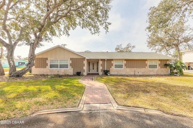 ranch-style home featuring a front yard