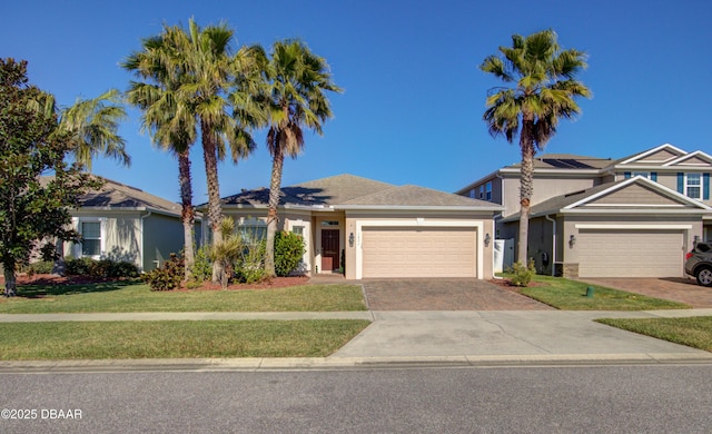 view of front facade with a garage and a front lawn