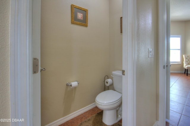 bathroom with tile patterned flooring and toilet