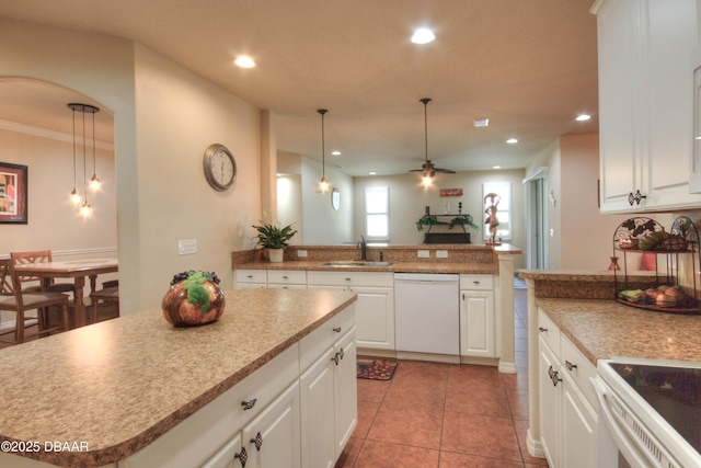 kitchen with dishwasher, ceiling fan, a kitchen island, sink, and white cabinetry