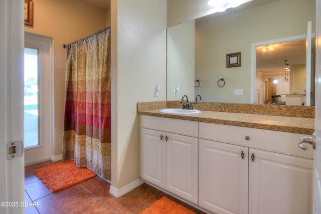 bathroom featuring tile patterned floors, vanity, and a shower with curtain