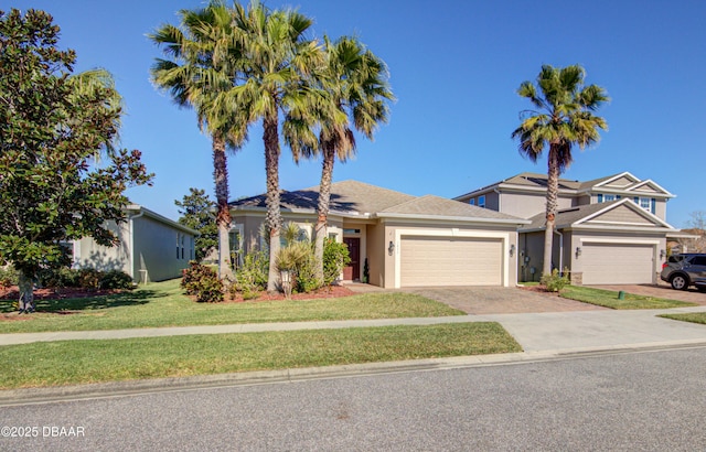 view of front of house with a front lawn and a garage