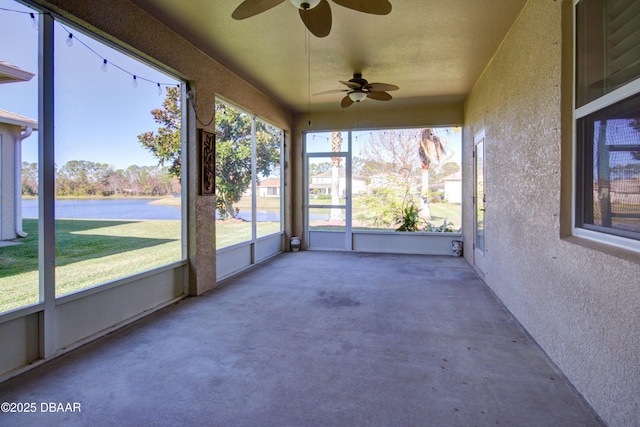 unfurnished sunroom featuring ceiling fan