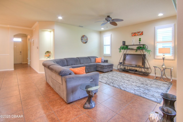 living room with ceiling fan, tile patterned flooring, and crown molding