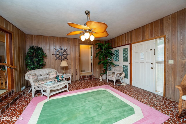 entryway with wood walls and ceiling fan