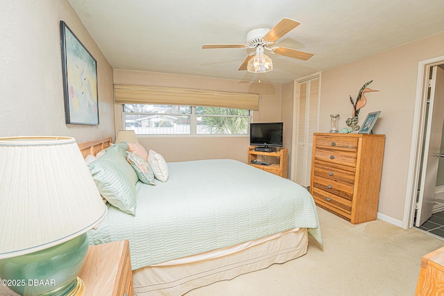 carpeted bedroom with ceiling fan, baseboards, and a closet