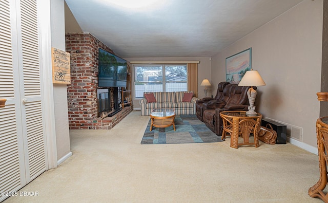 living area featuring carpet, a fireplace, and baseboards