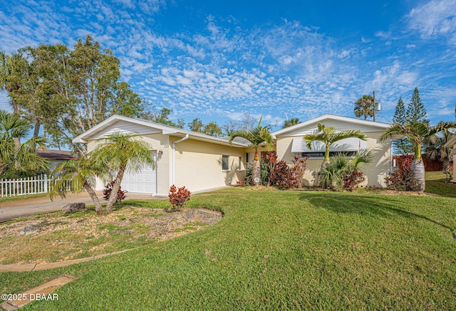 view of front facade featuring a garage, driveway, a front yard, and fence