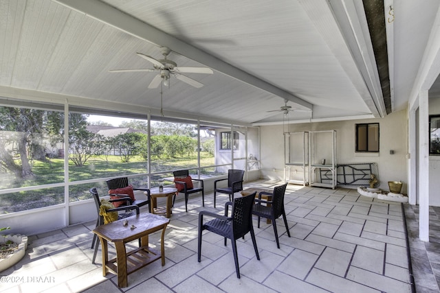 sunroom featuring beamed ceiling and ceiling fan