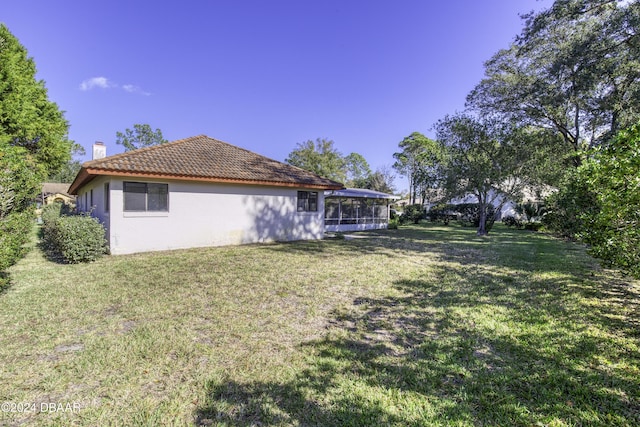 view of yard with a sunroom