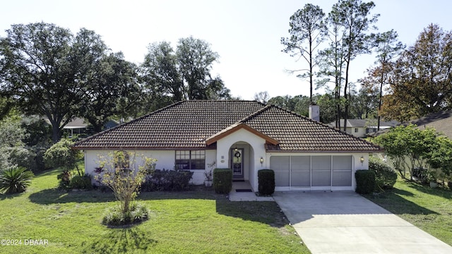 view of front of house with a front yard and a garage