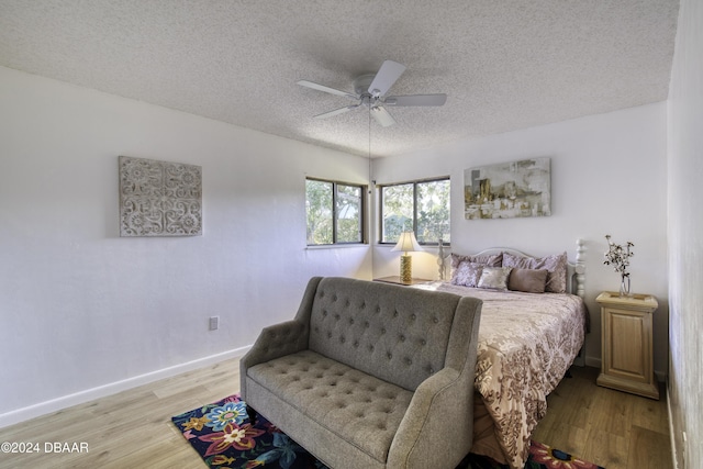 bedroom featuring ceiling fan, a textured ceiling, and hardwood / wood-style flooring