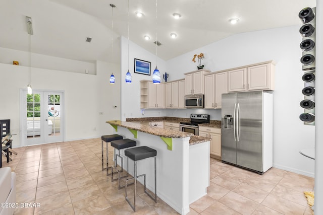 34 Raintree Cir, Palm Coast, FL 32164 - kitchen featuring appliances with stainless steel finishes, a breakfast bar area, high vaulted ceiling, dark stone counters, and pendant lighting