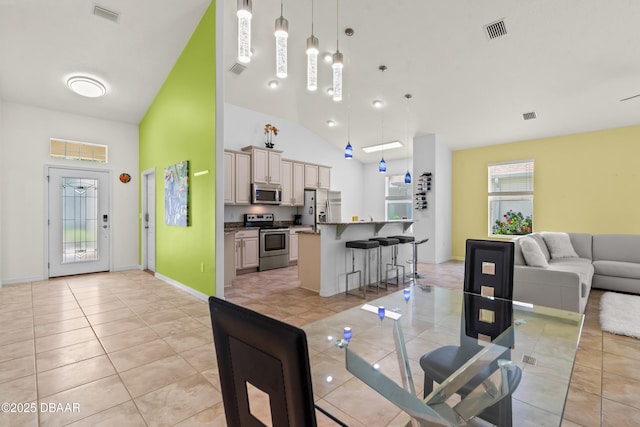 34 Raintree Cir, Palm Coast, FL 32164 - dining room with light tile patterned floors and high vaulted ceiling