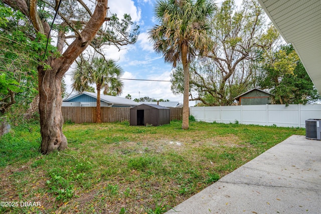 view of yard featuring central AC, a shed, an outdoor structure, and a fenced backyard