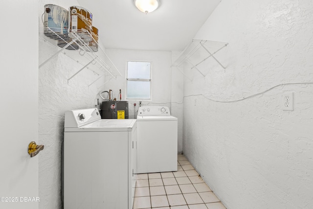 laundry room with a textured wall, light tile patterned flooring, electric water heater, separate washer and dryer, and laundry area