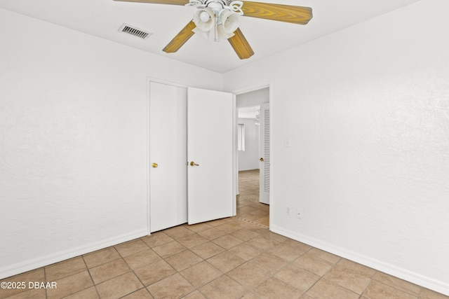 unfurnished bedroom with a ceiling fan, visible vents, and baseboards