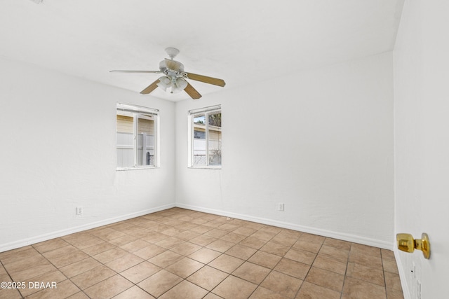 unfurnished room featuring ceiling fan and baseboards