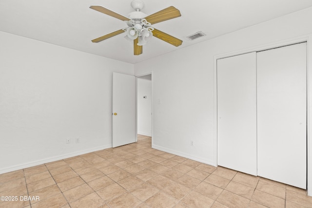 unfurnished bedroom with a ceiling fan, baseboards, visible vents, and a closet