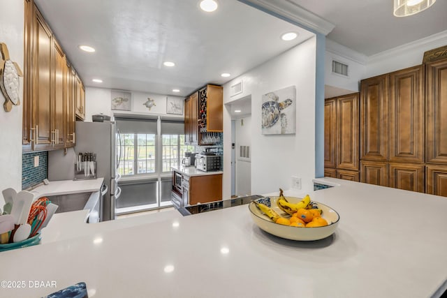 721 S Beach St Unit 215A, Daytona Beach, FL 32114 - kitchen with light countertops, recessed lighting, brown cabinets, tasteful backsplash, and a sink