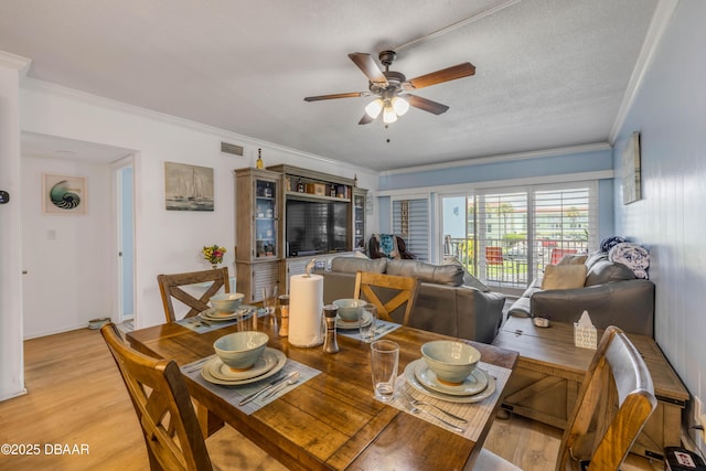 721 S Beach St Unit 215A, Daytona Beach, FL 32114 - dining area with ornamental molding, ceiling fan, light wood finished floors, and baseboards