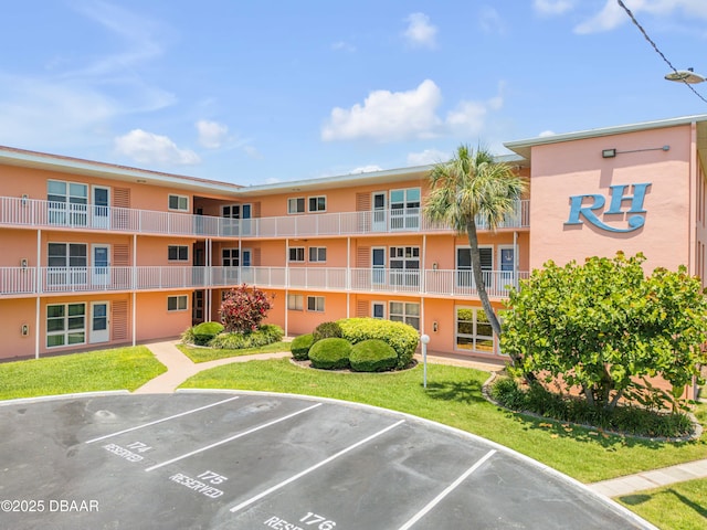 721 S Beach St Unit 215A, Daytona Beach, FL 32114 - view of apartment building / complex with uncovered parking