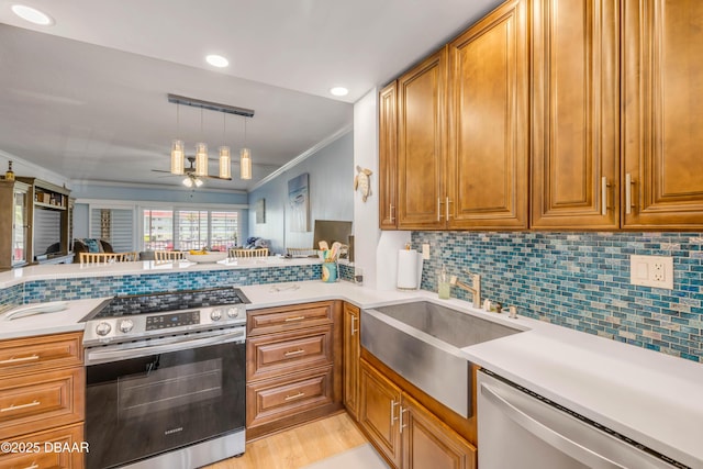 721 S Beach St Unit 215A, Daytona Beach, FL 32114 - kitchen with appliances with stainless steel finishes, ornamental molding, ceiling fan, light countertops, and brown cabinets