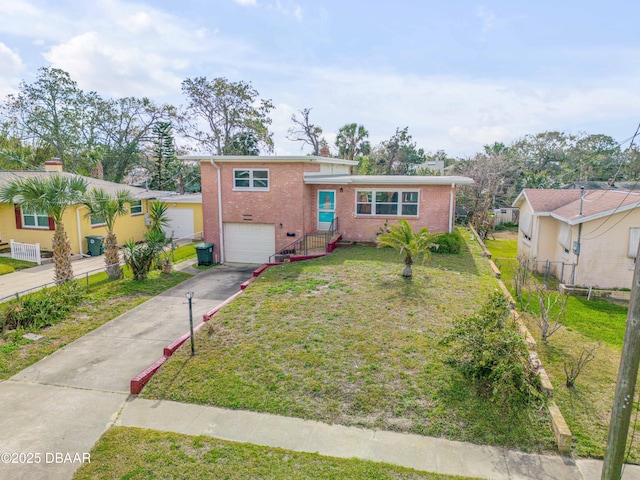 tri-level home with driveway, an attached garage, fence, and brick siding