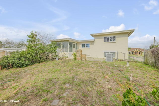 rear view of house with fence and central AC unit