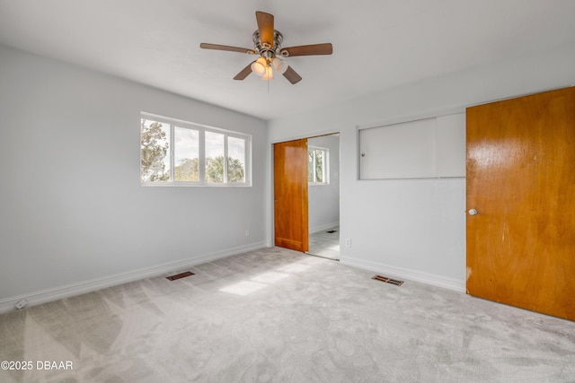 unfurnished bedroom with light carpet, baseboards, and visible vents