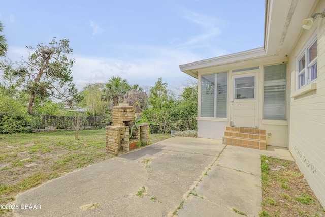 view of patio featuring entry steps and fence