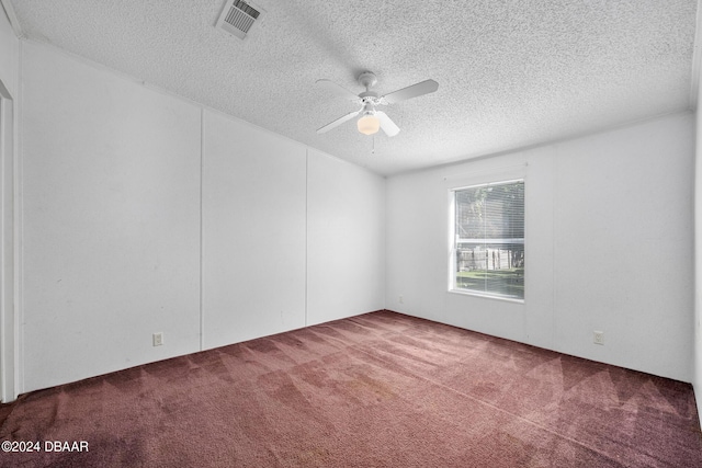 carpeted empty room with ceiling fan and a textured ceiling