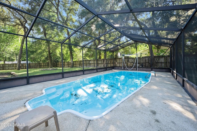 view of pool featuring a patio and glass enclosure