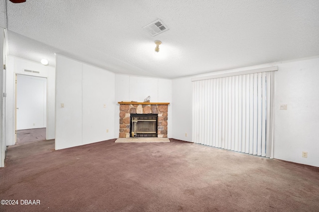 unfurnished living room featuring carpet flooring, a textured ceiling, and a fireplace