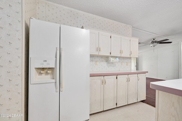 kitchen with ceiling fan, light colored carpet, white fridge with ice dispenser, and a textured ceiling