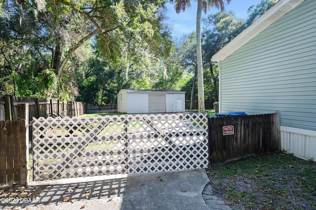 view of gate featuring a shed