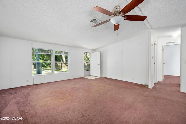 unfurnished living room with ceiling fan, carpet, and a textured ceiling