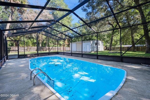 view of pool featuring a lanai, a patio area, a lawn, and a storage unit